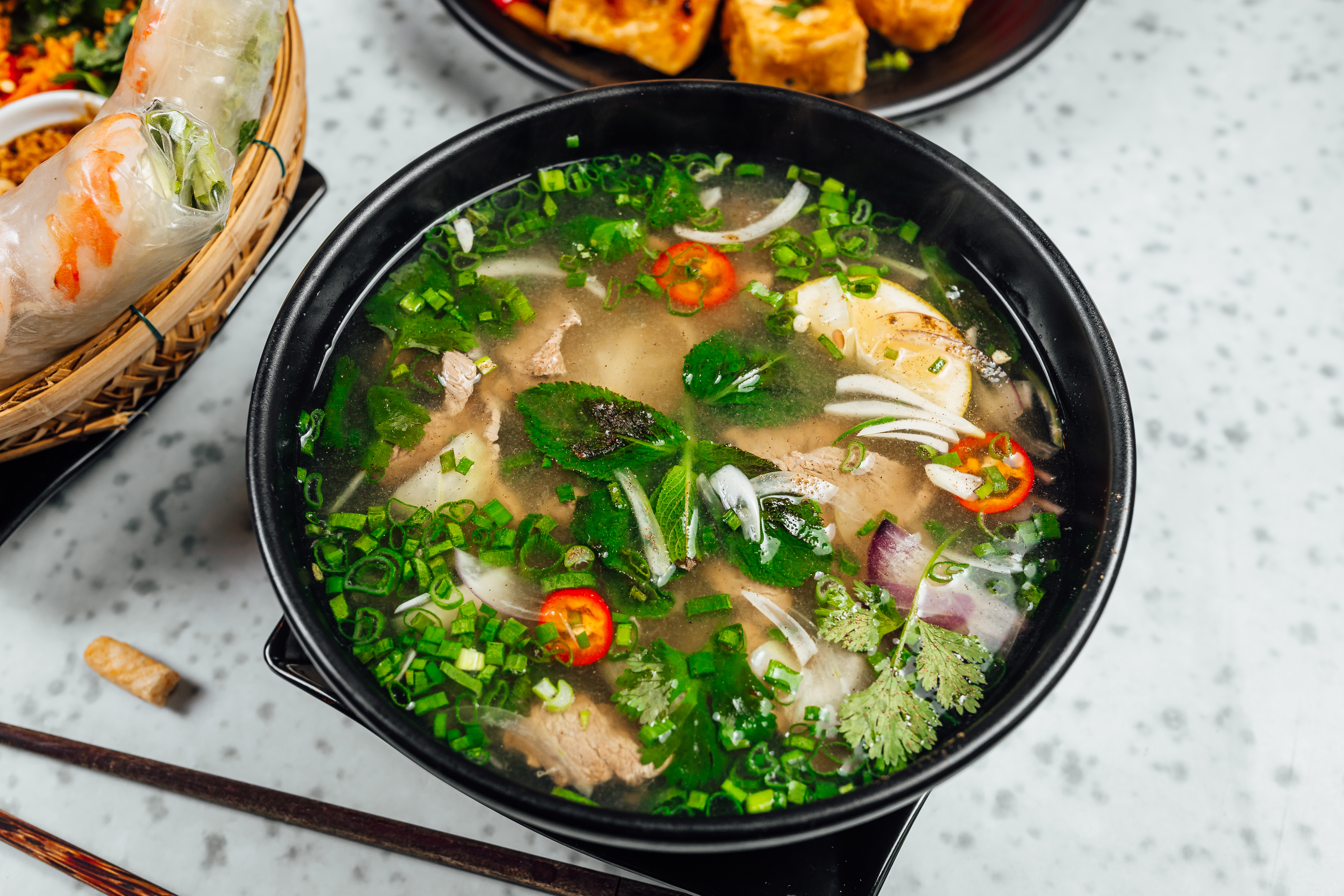 delicious-vietnamese-food-including-pho-ga-noodles-spring-rolls-white-table.jpg