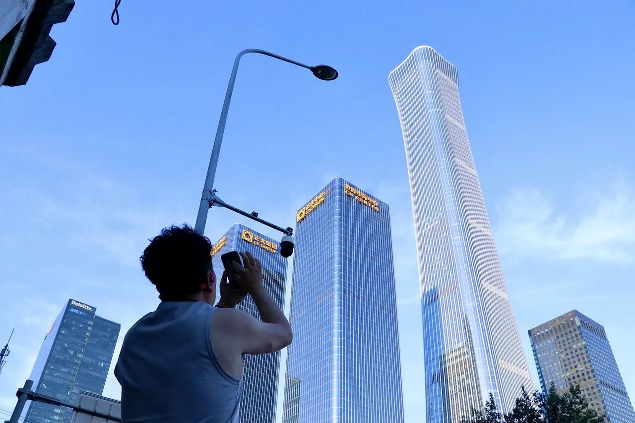 Người dân chụp lại dấu vết vụ máy bay hạng nhẹ đâm vào tòa tháp CITIC ở Bắc Kinh ngày 26-6 - Ảnh: UNITED DAILY NEWS