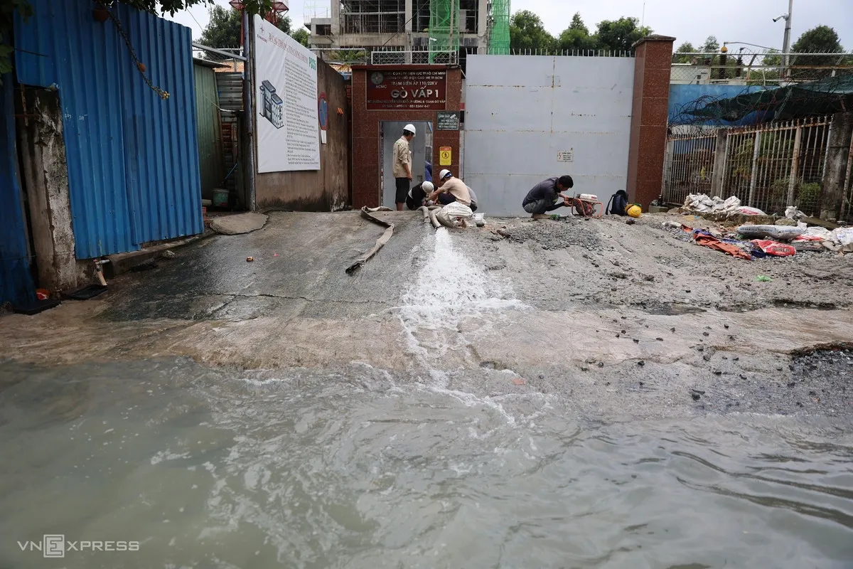 Tại trạm biến áp trên đường Nguyễn Văn Khối, nhóm công nhân dùng máy bơm hút nước ra ngoài.