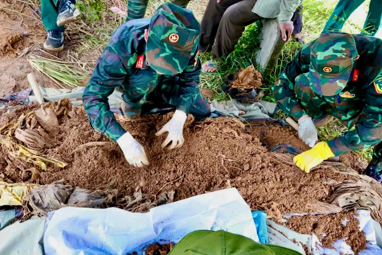 Hài cốt nữ liệt sĩ được phát hiện bọc trong hai lớp võng dù - Ảnh: QUỐC KHÁNH